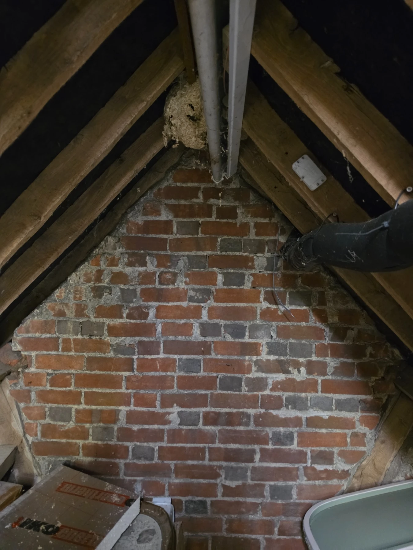 Roof-space photograph supplied by Leith Ecology, showing rafters and a brick gable